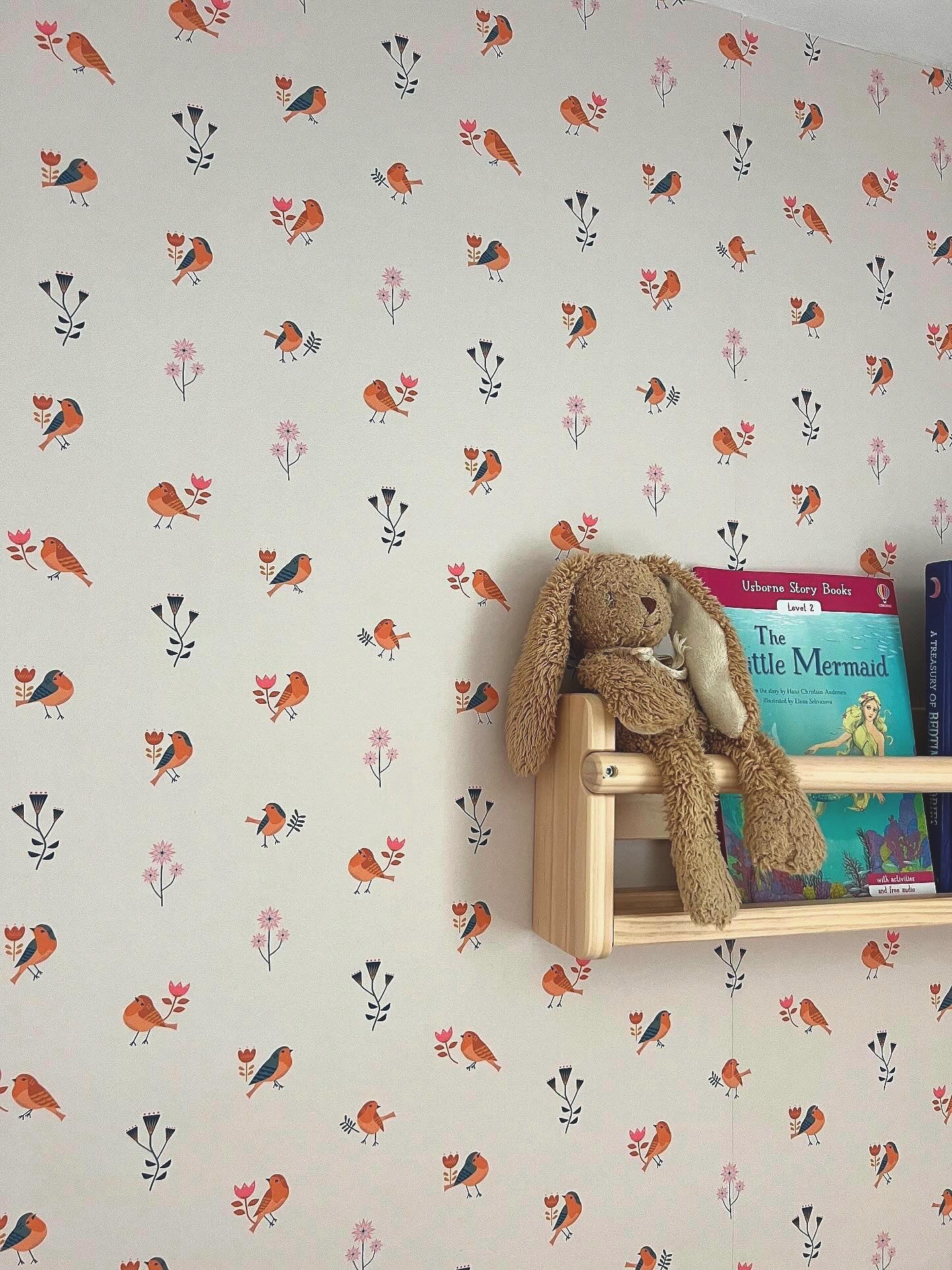 Nordic storybook-style children's room with whimsical wallpaper